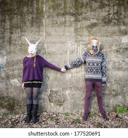 Young Hipster Couple Lovers Rabbit And Horse Mask At The Park