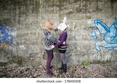 Young Hipster Couple Lovers Rabbit And Horse Mask At The Park