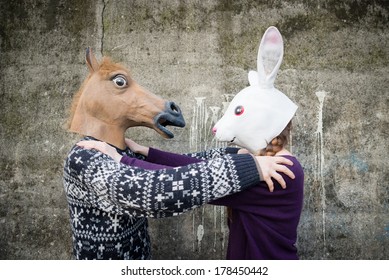 Young Hipster Couple Lovers Rabbit And Horse Mask At The Park