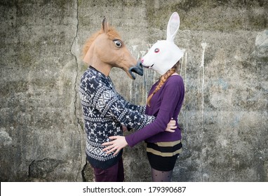 Young Hipster Couple Lovers Rabbit And Horse Mask At The Park