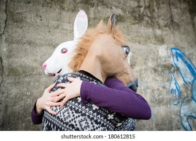 Young Hipster Couple Lovers Rabbit And Horse Mask At The Park