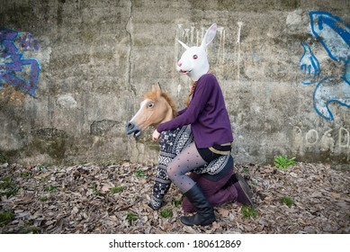 Young Hipster Couple Lovers Rabbit And Horse Mask At The Park