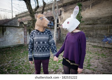 Young Hipster Couple Lovers Rabbit And Horse Mask At The Park