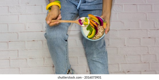 Young Hipster Eating Yogurt Parfait ,avocado,banana,as Granola Parfait In A Bowl -Banner Diet Plan Concept