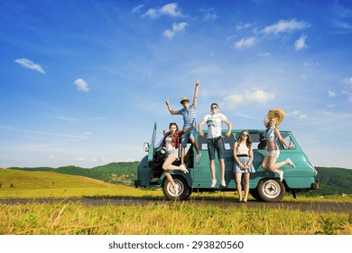 Young Hipster Friends On Road Trip On A Summers Day