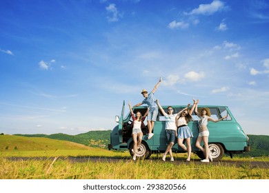 Young Hipster Friends On Road Trip On A Summers Day