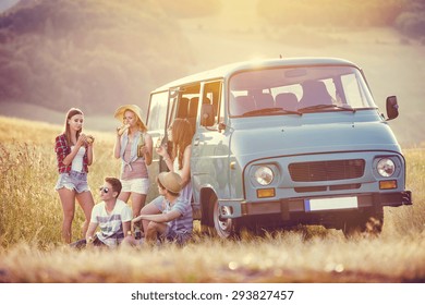 Young Hipster Friends On Road Trip On A Summers Day