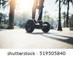 Young hipster girl driving on hoverboard at sunny park, active woman balancing on modern electric segway, alternative transport concept, ecology and environment concept, flare light