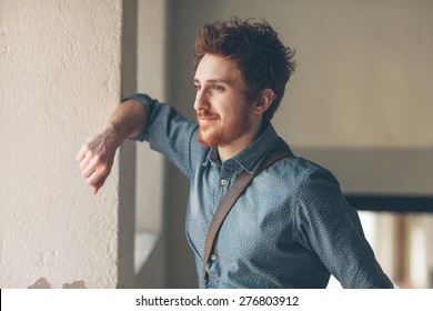 Young hipster looking away and leaning on a wall - Powered by Shutterstock