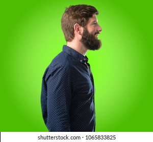 Young Hipster Man With Big Beard Side View Portrait Over Green Background