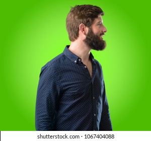 Young Hipster Man With Big Beard Side View Portrait Over Green Background