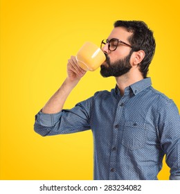 Young Hipster Man Drinking Coffee Over Colorful Background