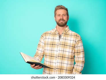 Young hipster man reading a book isolated over green background. - Powered by Shutterstock