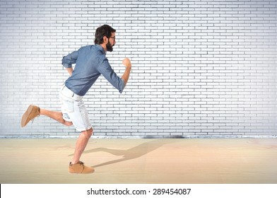 Young hipster man running fast over textured background - Shutterstock ID 289454087