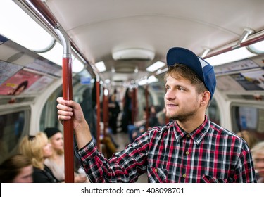 Young Hipster Man Standing In A Crowded Subway Train