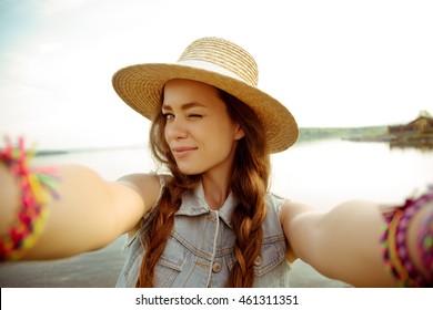 Young Hipster Woman In Stylish Hat Making Selfie, Funny Face, Posing At Countryside At Summer Day
