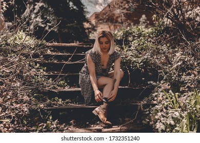 Young Hipster Woman Travels In Colorado Forest. Long Dress, Chelsea Boots, Black Hat. Blonde Millennial Lady. Freedom. Escape Home. Local Traveling. Exploring Places. Travel Locally. Travel Anxiety.