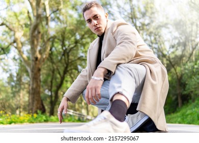 Young hispanic arab man posing in the road looking at camera.