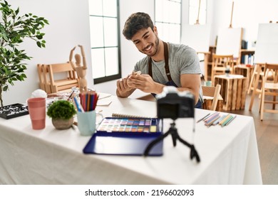 Young Hispanic Artist Man Smiling Happy Making Online Art Class At Studio.