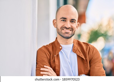 Young Hispanic Bald Man Smiling Happy Standing At The City.