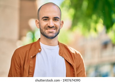 Young Hispanic Bald Man Smiling Happy Standing At The City.