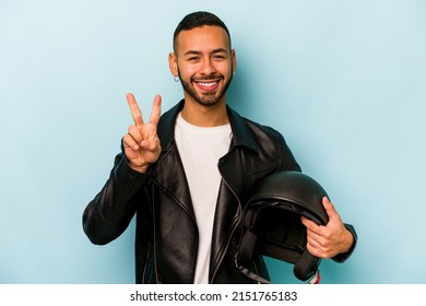 Young hispanic biker man isolated on blue background showing number two with fingers. - Shutterstock ID 2151765183