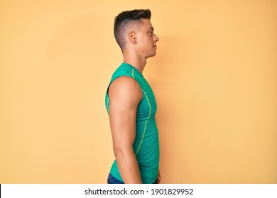 Young hispanic boy wearing sporty style with sleeveless shirt looking to side, relax profile pose with natural face with confident smile.  - Powered by Shutterstock