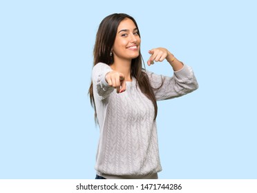 Young Hispanic Brunette Woman Points Finger At You While Smiling Over Isolated Background