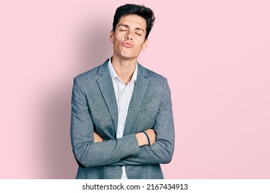 Young Hispanic Business Man With Arms Crossed Gesture Looking At The Camera Blowing A Kiss Being Lovely And Sexy. Love Expression. 