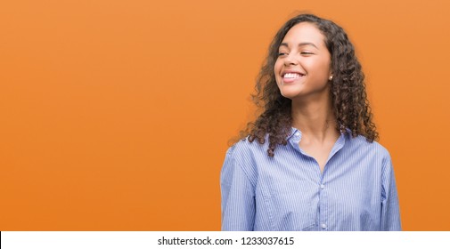 Young Hispanic Business Woman Looking Away To Side With Smile On Face, Natural Expression. Laughing Confident.