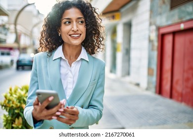 Young Hispanic Business Woman Wearing Professional Look Smiling Confident At The City Using Smartphone