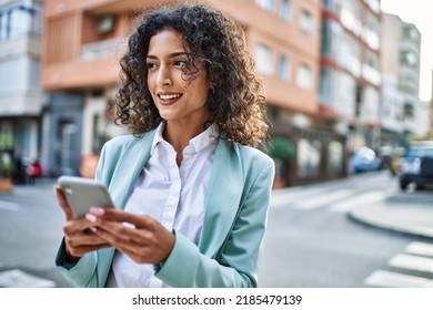 Young Hispanic Business Woman Wearing Professional Look Smiling Confident At The City Using Smartphone