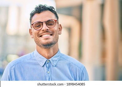 Young hispanic businessman smiling happy standing at the city. - Shutterstock ID 1898454085