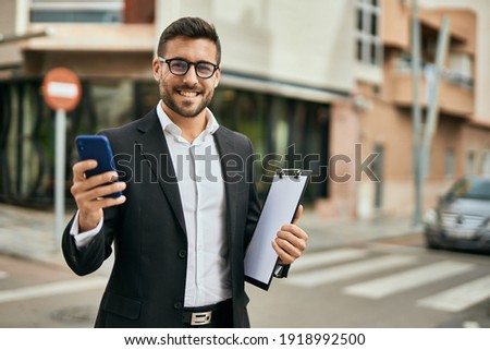 Similar – Mann im Anzug läuft mit dem Handy in der Hand durch die Stadt