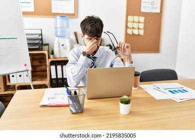 Young Hispanic Businessman Stressed Working At The Office.