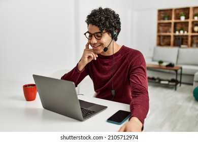 Young Hispanic Call Center Agent Man Working At Home.