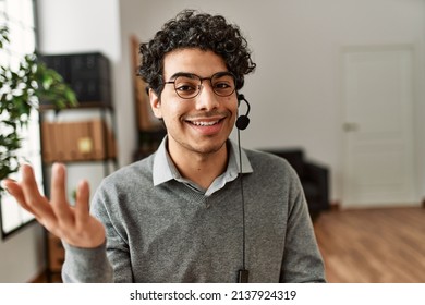 Young Hispanic Call Center Agent Man Smiling Happy Working At The Office.