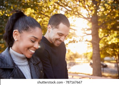 Young Hispanic Couple Walking In Brooklyn Park, Close Up