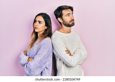 Young Hispanic Couple Wearing Casual Clothes Looking To The Side With Arms Crossed Convinced And Confident 