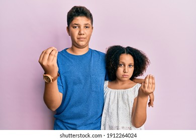 Young Hispanic Family Of Brother And Sister Wearing Casual Clothes Together Doing Italian Gesture With Hand And Fingers Confident Expression 