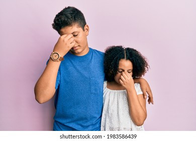 Young Hispanic Family Of Brother And Sister Wearing Casual Clothes Together Tired Rubbing Nose And Eyes Feeling Fatigue And Headache. Stress And Frustration Concept. 