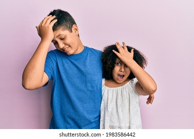 Young Hispanic Family Of Brother And Sister Wearing Casual Clothes Together Surprised With Hand On Head For Mistake, Remember Error. Forgot, Bad Memory Concept. 