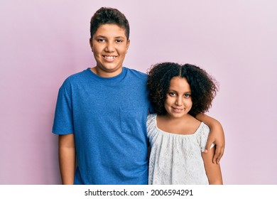 Young Hispanic Family Of Brother And Sister Wearing Casual Clothes Together With A Happy And Cool Smile On Face. Lucky Person. 