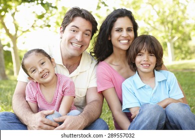 Young Hispanic Family Relaxing In Park