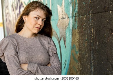 A Young Hispanic Female Standing With Crossed Arms