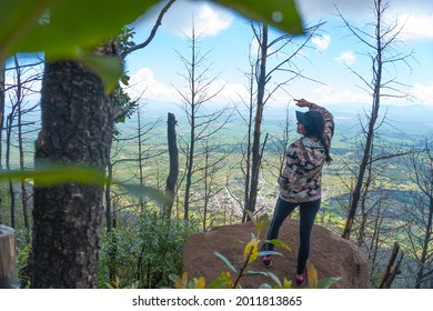 A Young Hispanic Female Standing On A Rock And Enjoying The Beautiful Nature