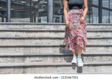 A Young Hispanic Female Standing On The Stairs Outdoors