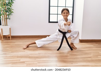 Young hispanic girl doing martial arts at training studio - Powered by Shutterstock