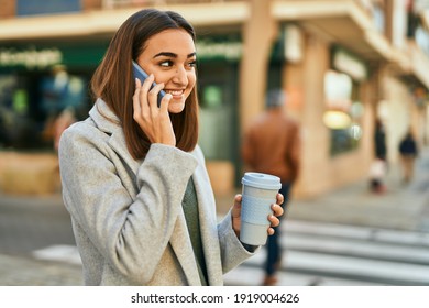 Young Hispanic Girl Talking On The Smartphone Drinking Coffee At The City.