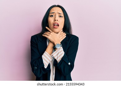 Young hispanic girl wearing business clothes shouting and suffocate because painful strangle. health problem. asphyxiate and suicide concept. 